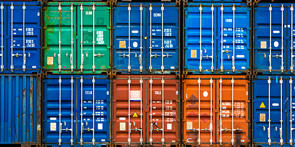 Colorful containers stacked in port yard.