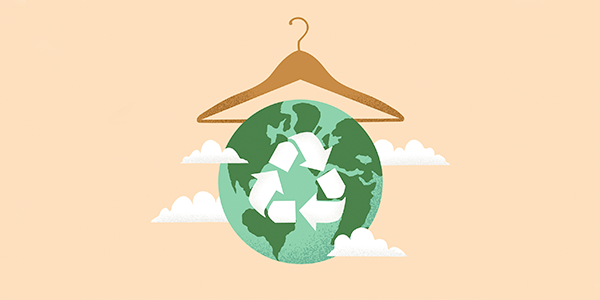 Green colored earth with recycling symbol hanging from a clothes hanger.