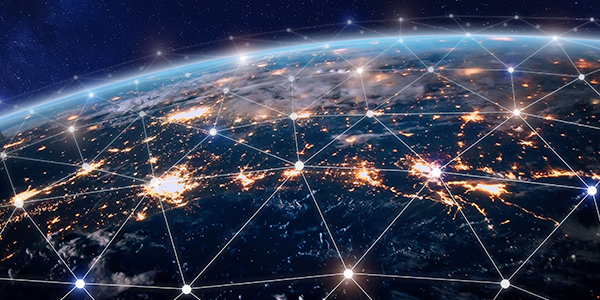 View of Earth from space with glowing city lights connected by white network lines and nodes, symbolizing global connectivity and digital communication.