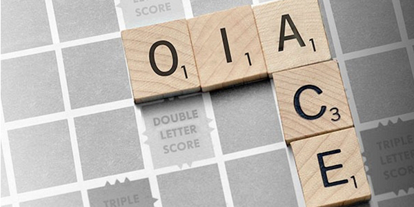 Scrabble board featuring OIA and ACE connecting words.