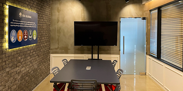 Meeting room and television inside OIA Global's new office location in Busan, Korea.