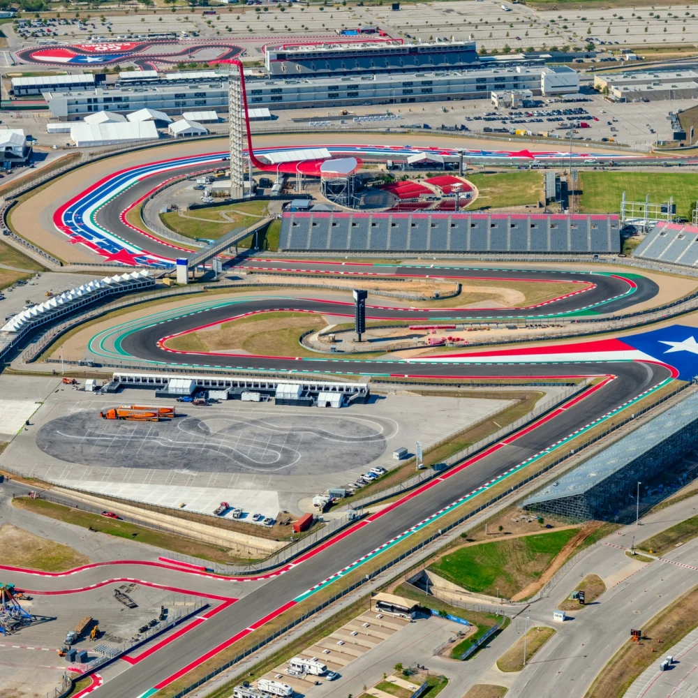 Aerial view of Circuit of the Americas racetrack in Austin, Texas with colorful track design and grandstands.