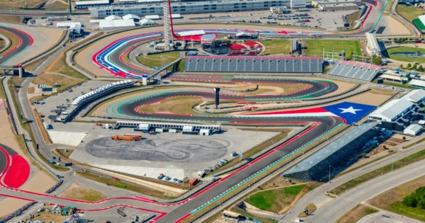 Aerial view of Circuit of the Americas racetrack in Austin, Texas with colorful track design and grandstands.