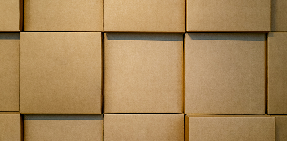 carton optimization header - rows of organized boxes in a warehouse facility