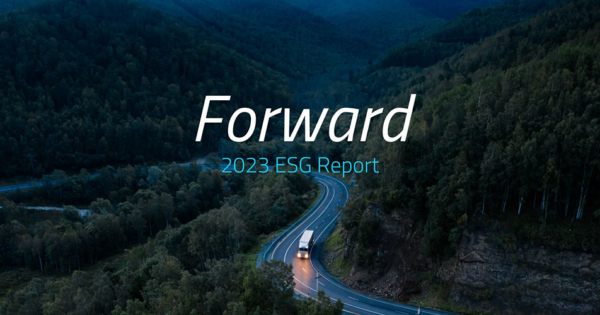Truck driving on a winding road through a forested mountain landscape with “Forward 2023 ESG Report” text overlay.