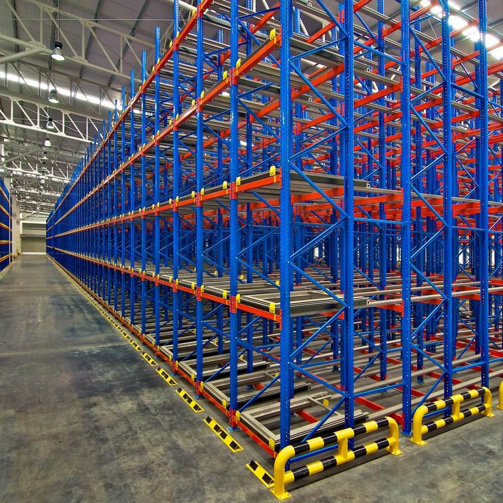 Empty warehouse with multi-level pallet racking system in blue and orange, designed for high-density storage and logistics operations.