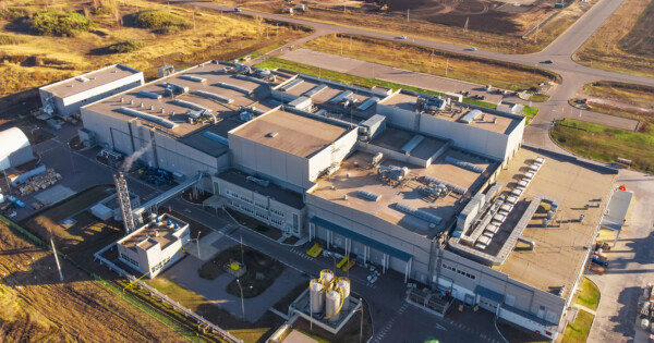 Aerial view of a large industrial logistics facility with warehouse buildings, loading docks, and surrounding road infrastructure.