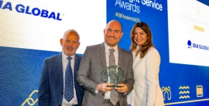 Representatives receiving a BIFA Freight Service Award on stage during an industry awards ceremony.