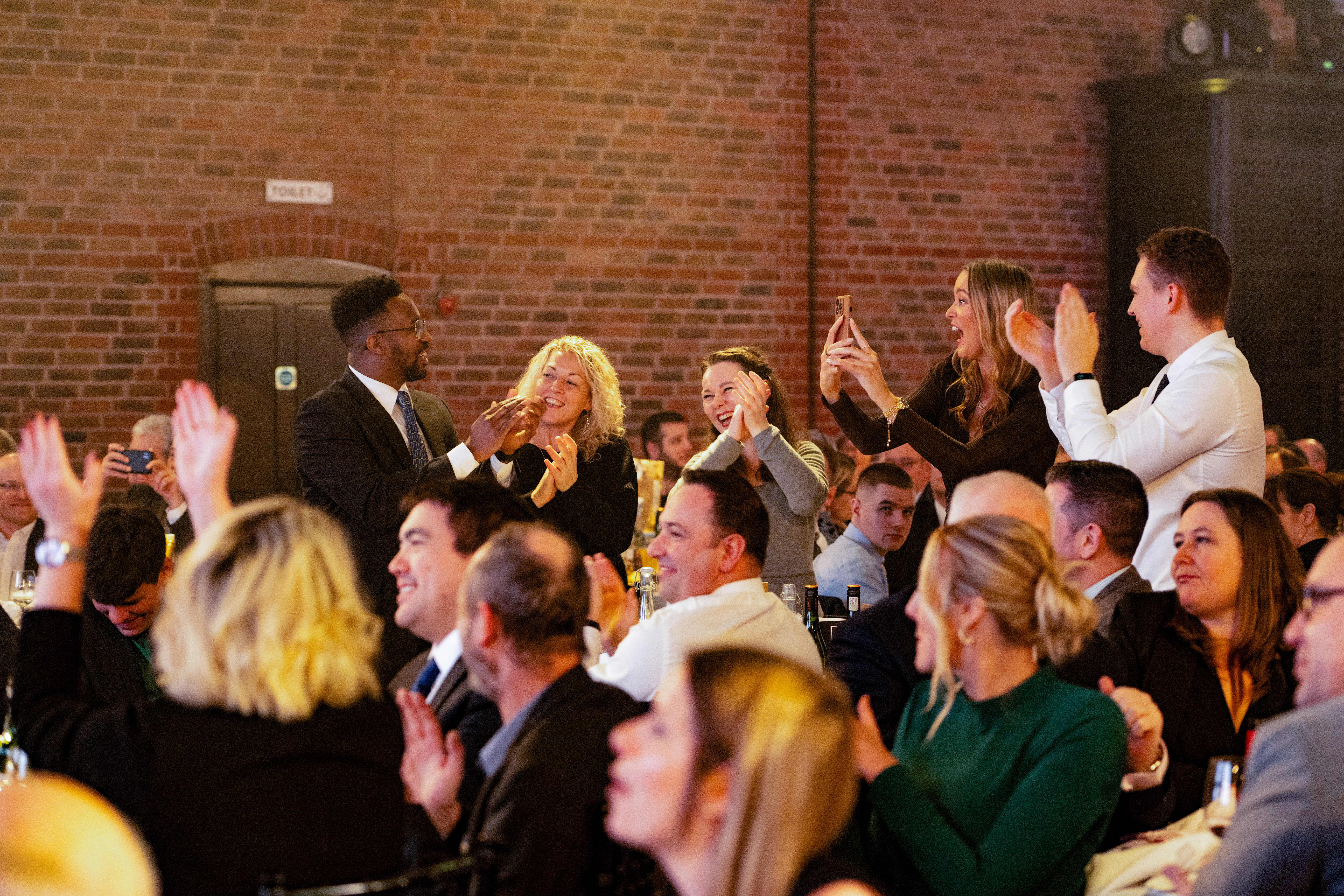 BIFA Staff Development Award recipients clapping for OIA Global's victory at the annual Freight Awards ceremony.