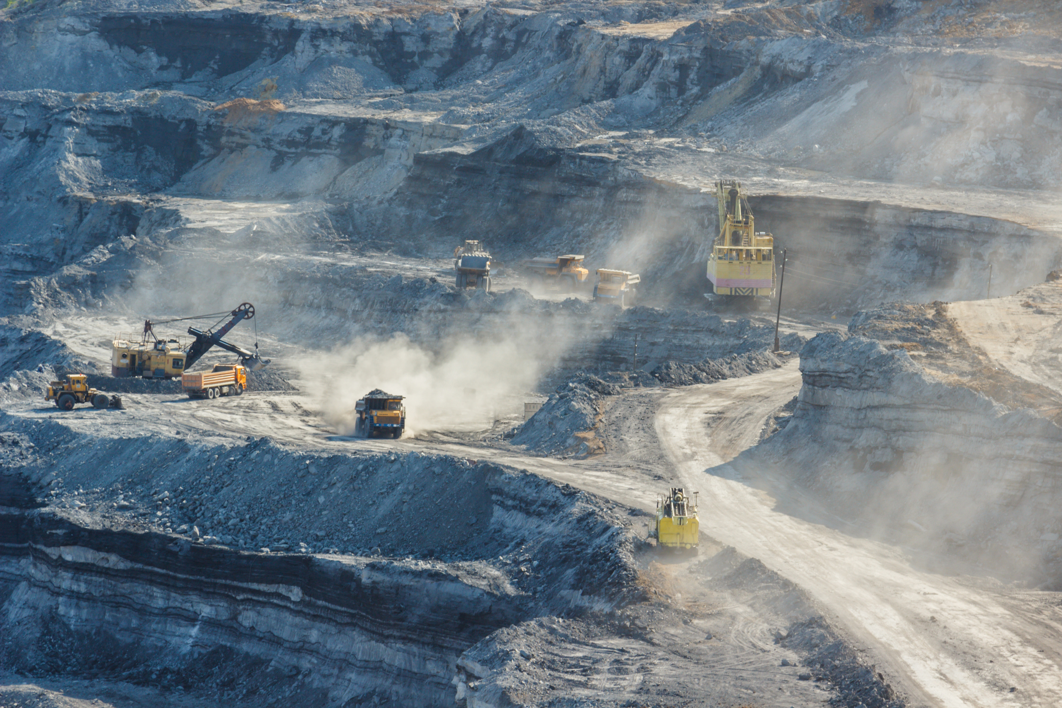 Copperbelt mining concept with multiple road consolidation vehicles moving raw materials.