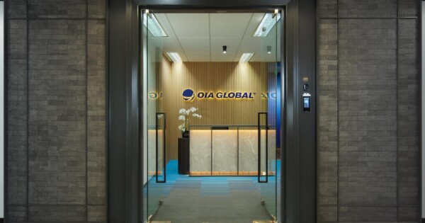 OIA Global Jakarta office reception area with glass entrance doors and branded front desk.