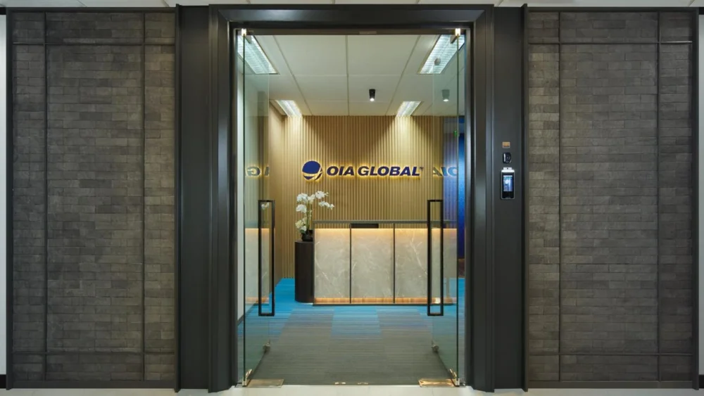 OIA Global Jakarta office reception area with glass entrance doors and branded front desk.