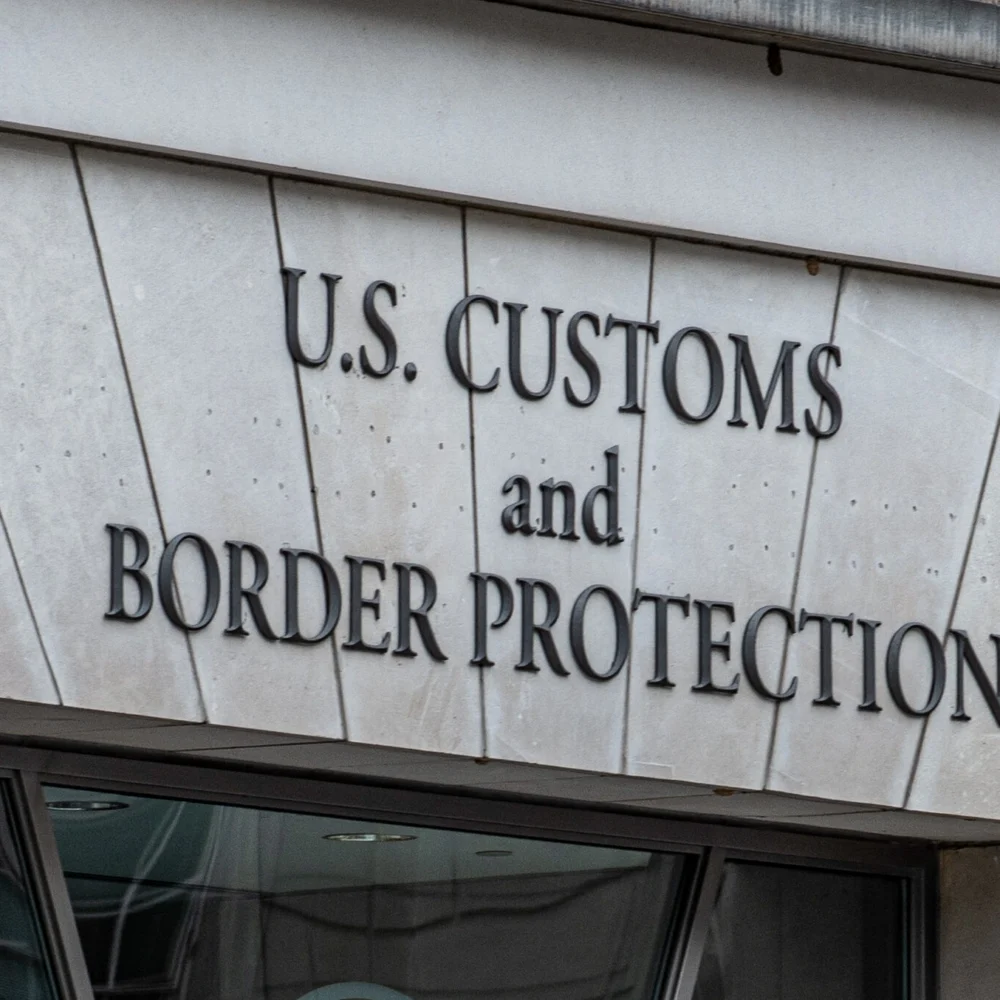 U.S. Customs and Border Protection sign on a government building exterior.